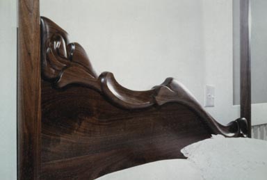 carved walnut canopy bed headboard detail