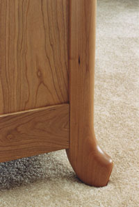 Carved cherry dresser side and leg detail