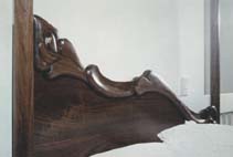 carved walnut canopy bed headboard detail